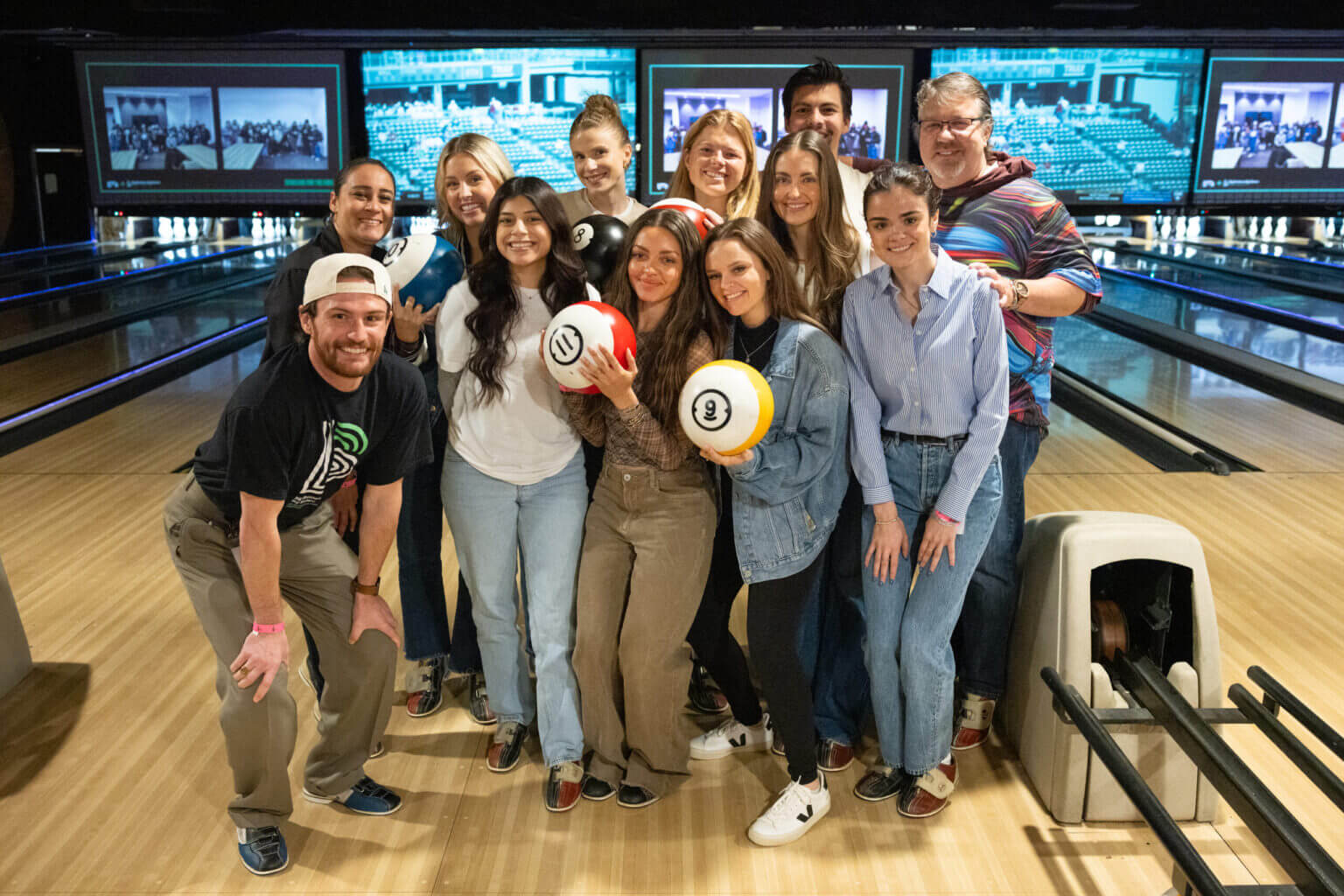 A group of tms mentors posing for a photo at a bowling alley