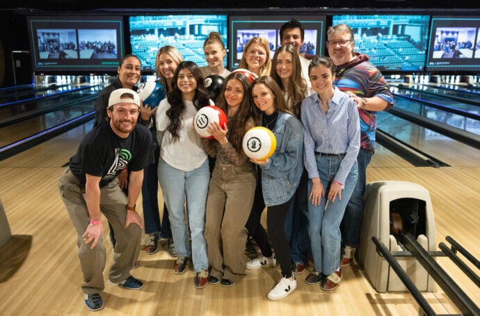 A group of tms mentors posing for a photo at a bowling alley