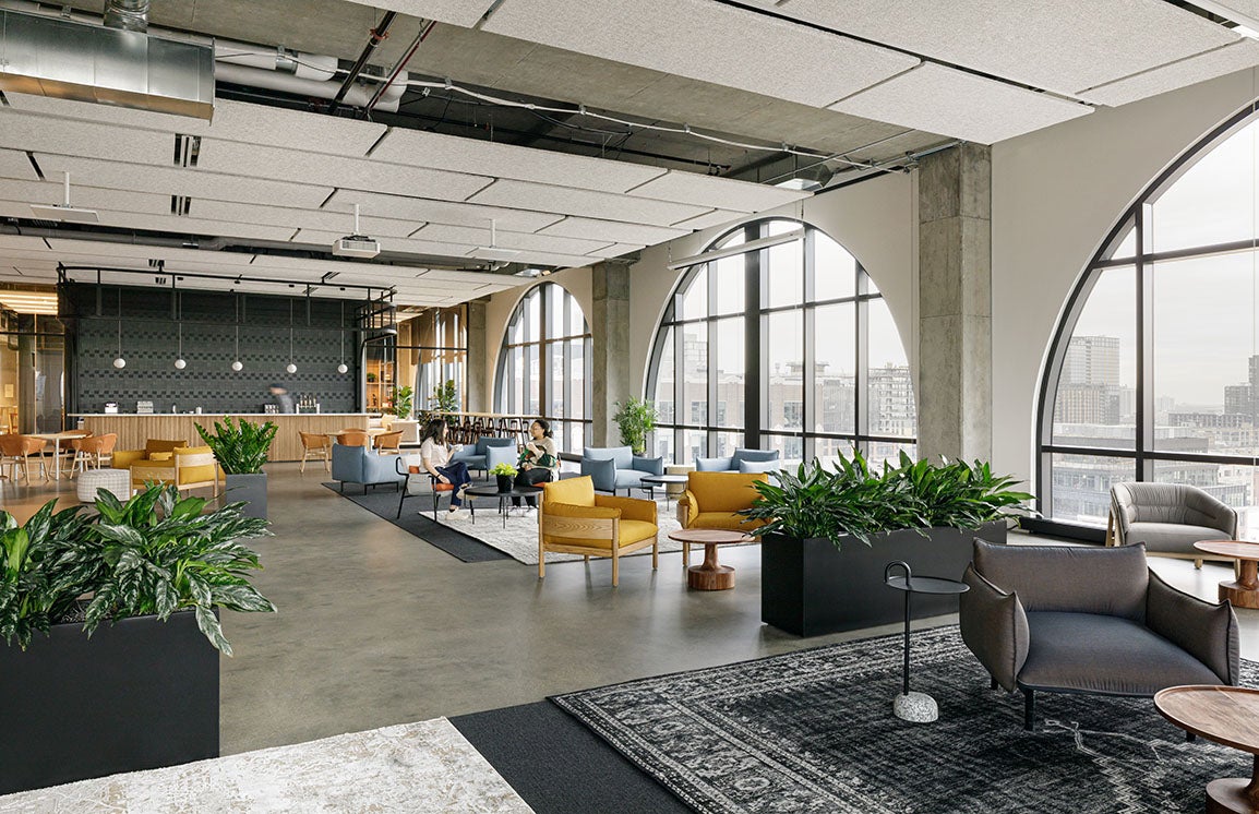 Two people sitting inside tms' Chicago Headquarters