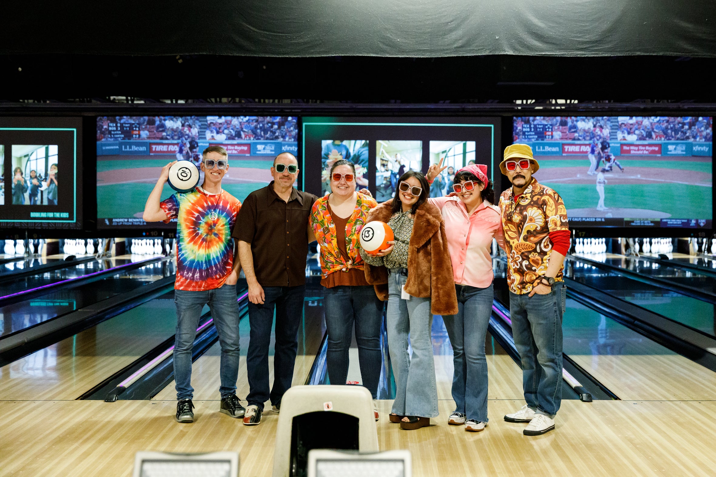 tms colleagues posing for a photo in a bowling alley