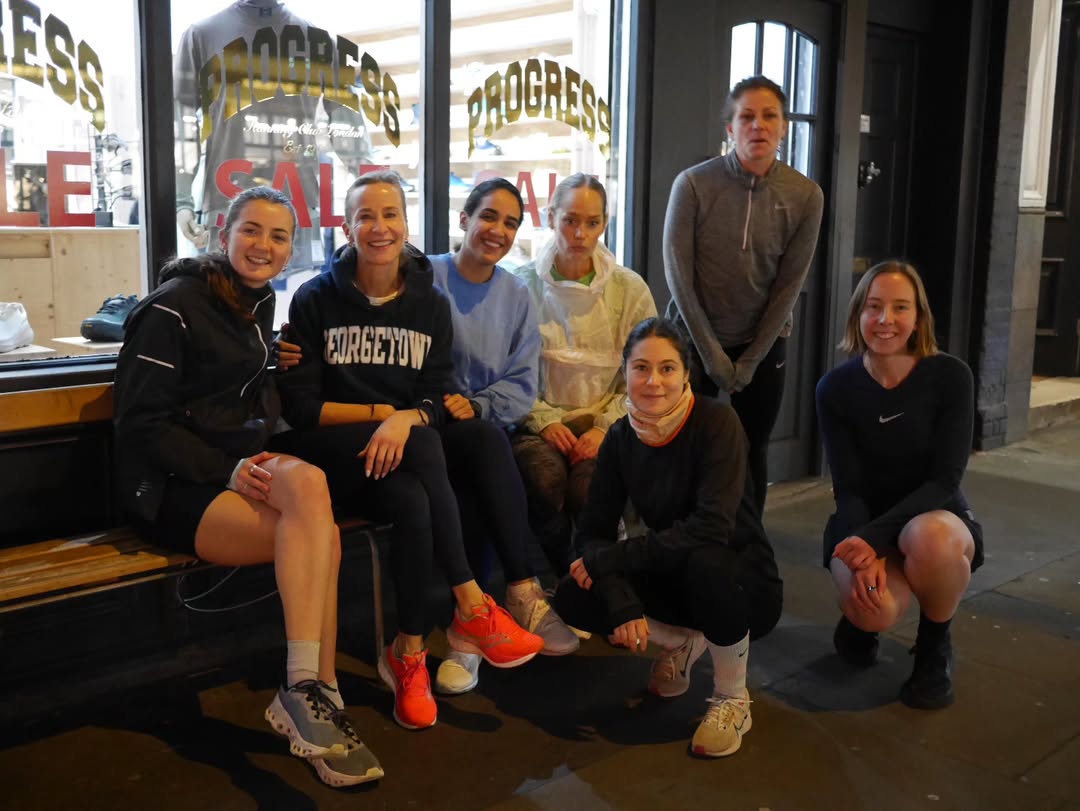 A group of people in running gear posing for a photo