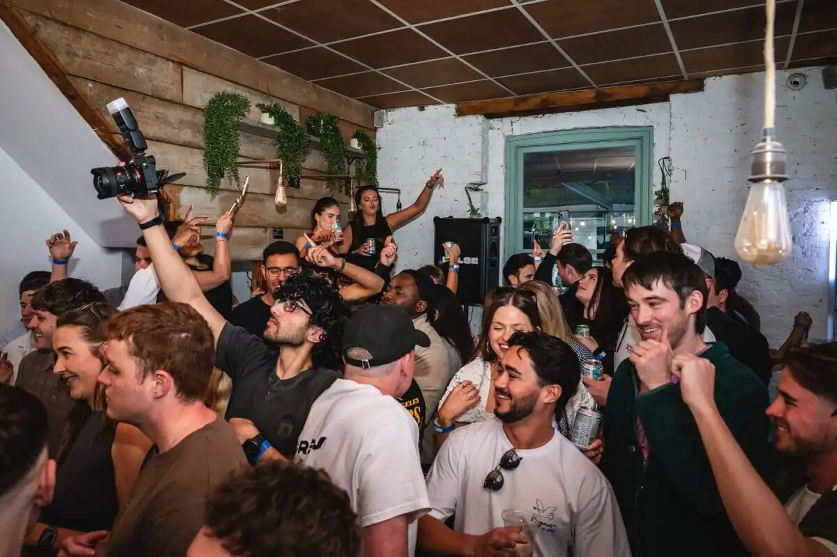 A large crowd of people partying inside