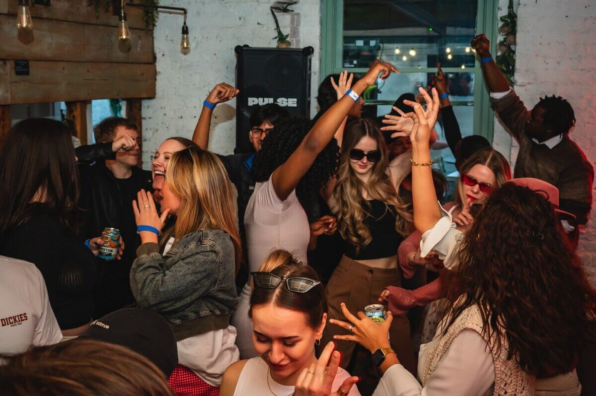 A large crowd of people partying inside