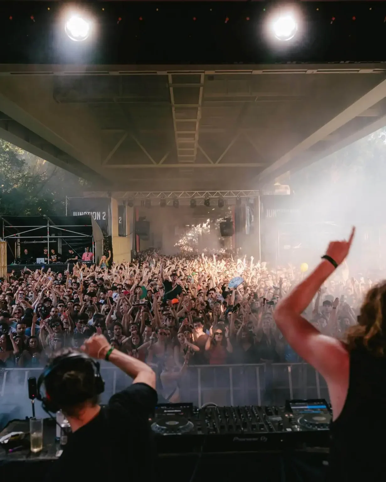 DJ performing to a large crowd at a concert