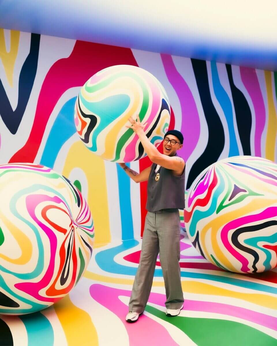 adults holding giant painted balloons