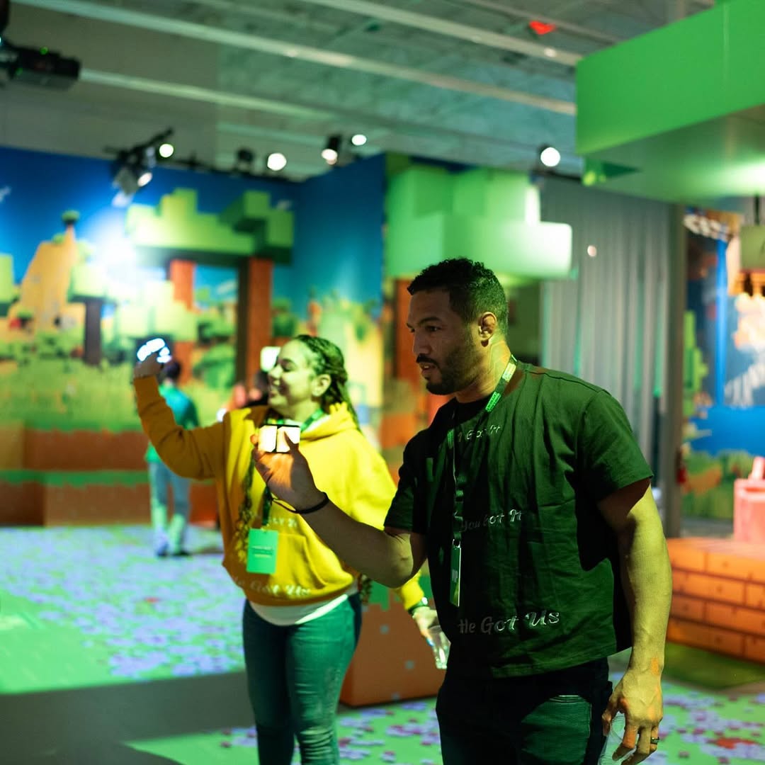 man and woman playing with interactive glowing objects