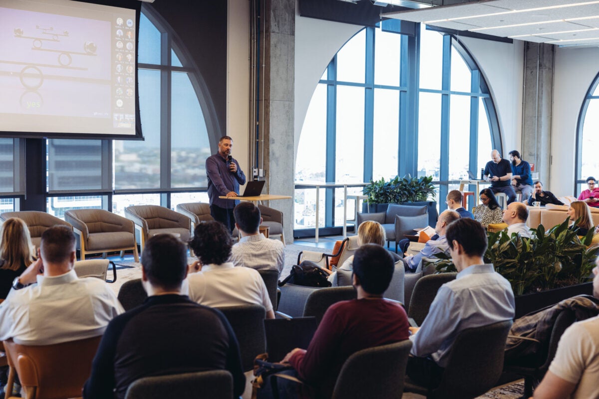 Brian Barthelt speaking to crowd at AI summit