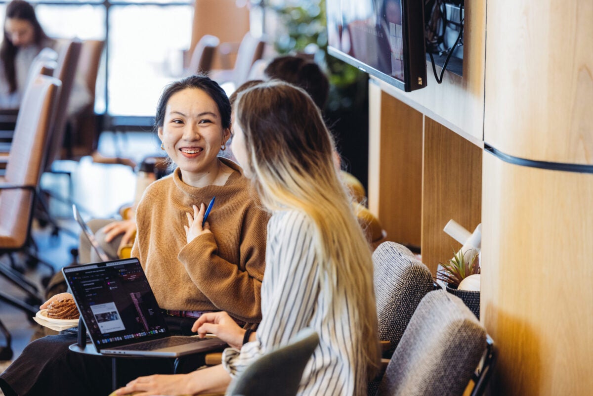 People conversing at the AI summit