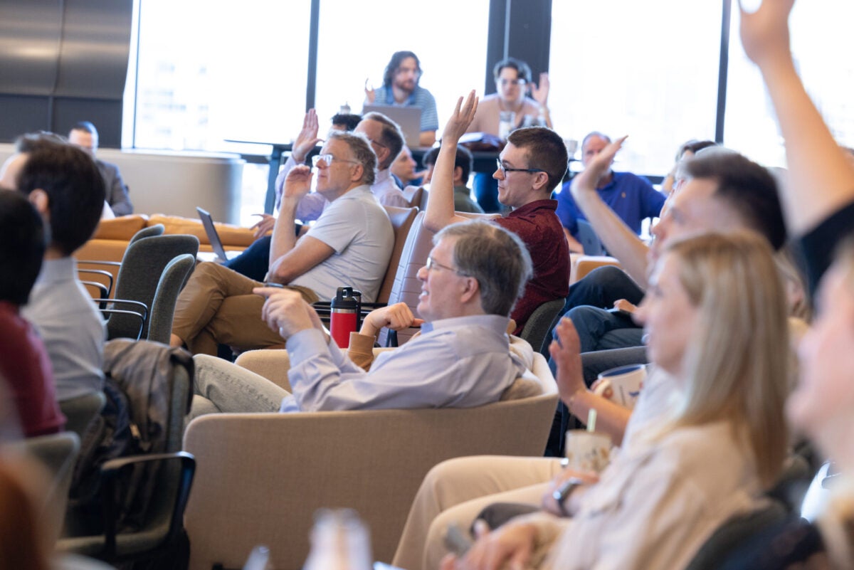 People raising hands at the AI summit