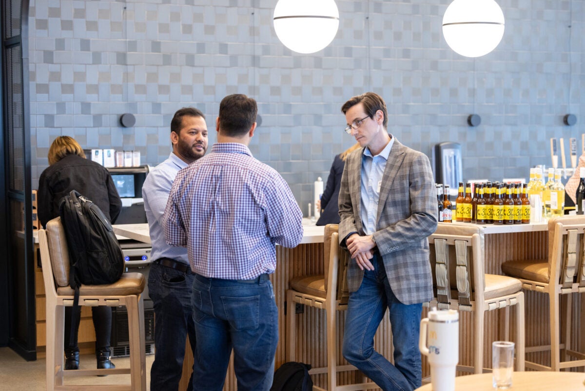 People conversing at the AI summit