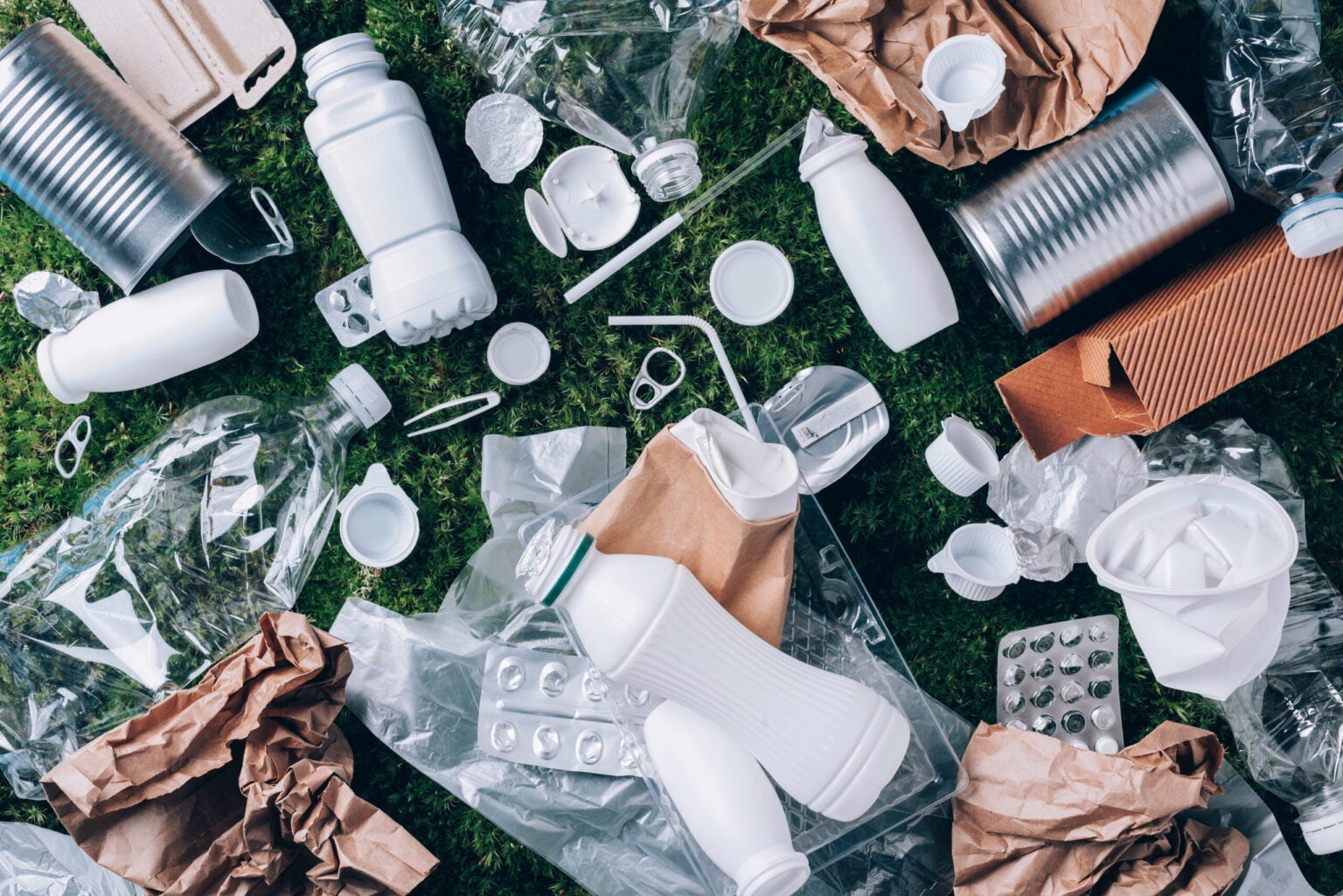 collection of trash and packaging on the grass
