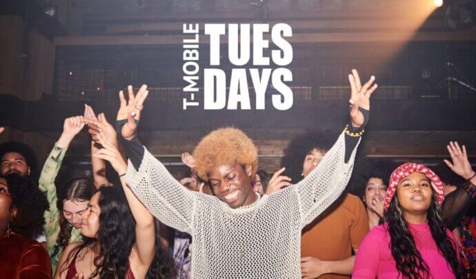 A group of people dancing with the "T-Mobile Tuesdays" logo in the top center
