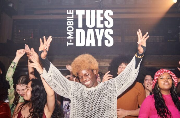 A group of people dancing with the "T-Mobile Tuesdays" logo in the top center