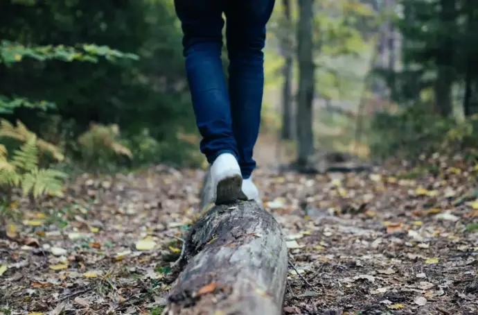 Hiker walking on a log