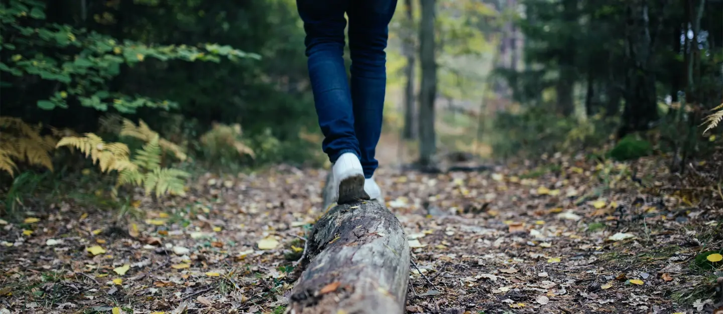 Hiker walking on a log