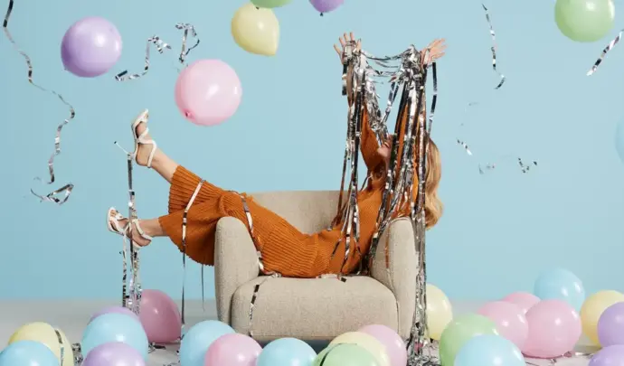 Person on couch with balloons