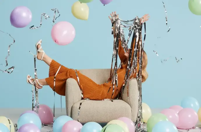 Person on couch with balloons