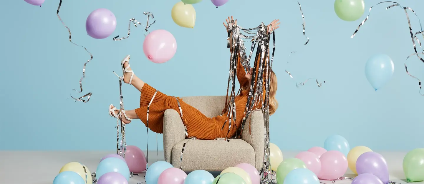 Person on couch with balloons