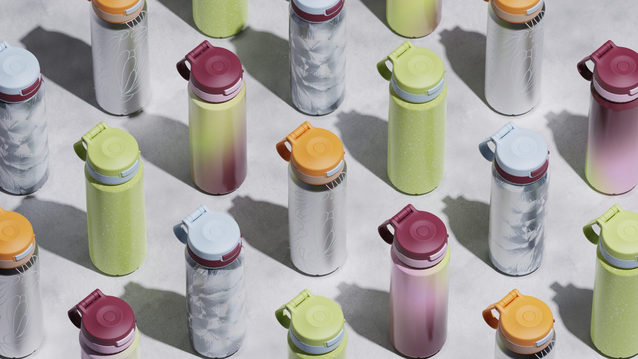 A lineup of tumblers with orange, blue, and green tops