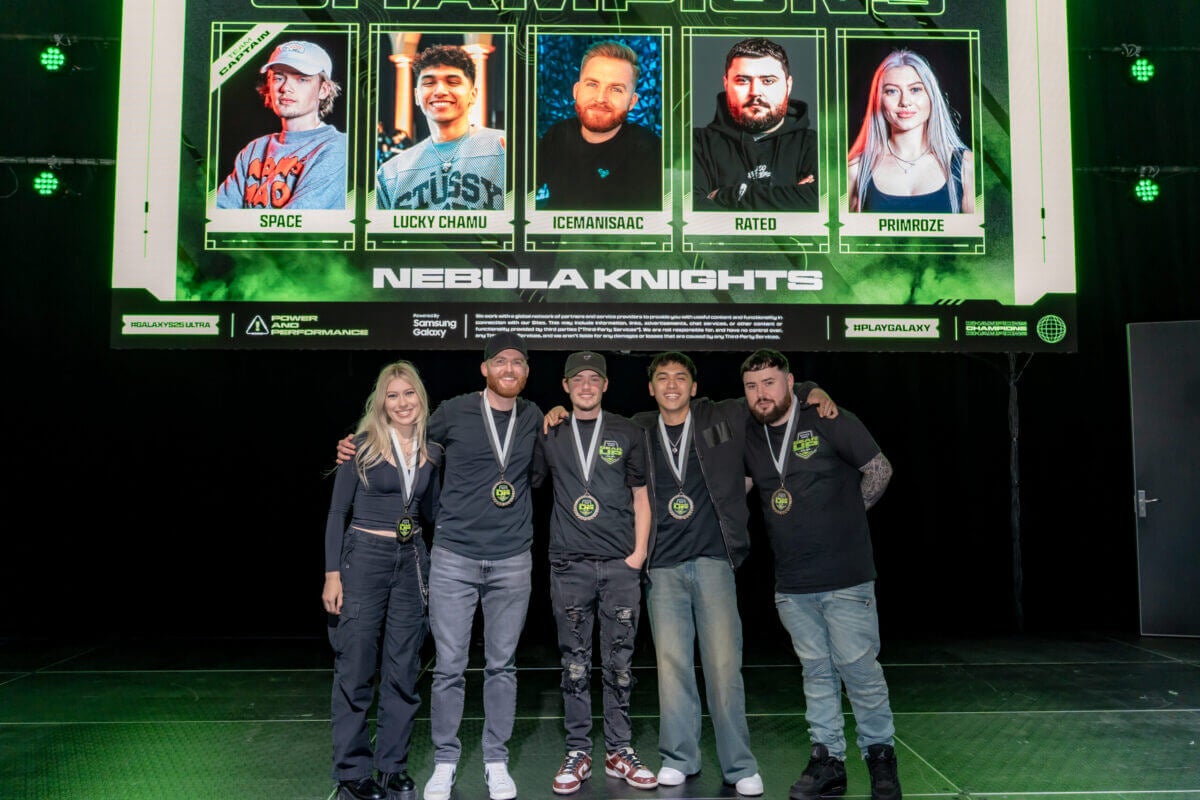 Gamers posing for a photo in front of a screen