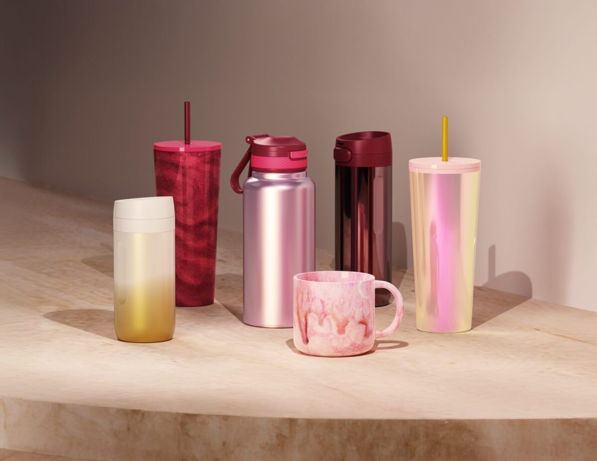 Pink and red tumblers and mugs against a neutral background
