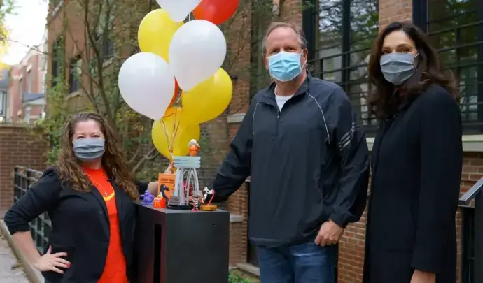 people with balloons and masks