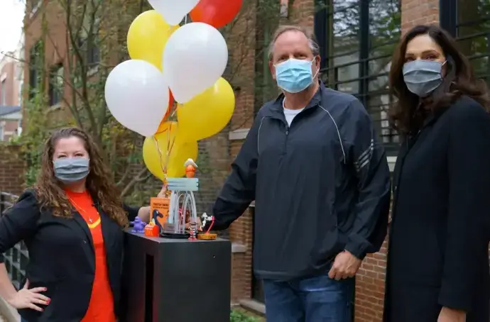 people with balloons and masks