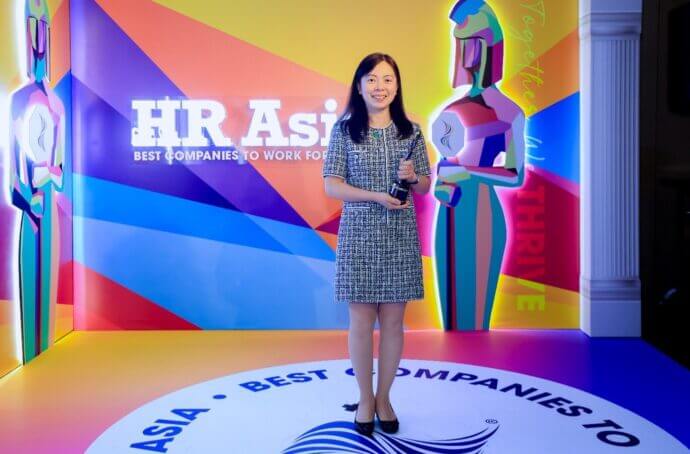 Femme tenant un trophée lors d’une cérémonie de remise de prix