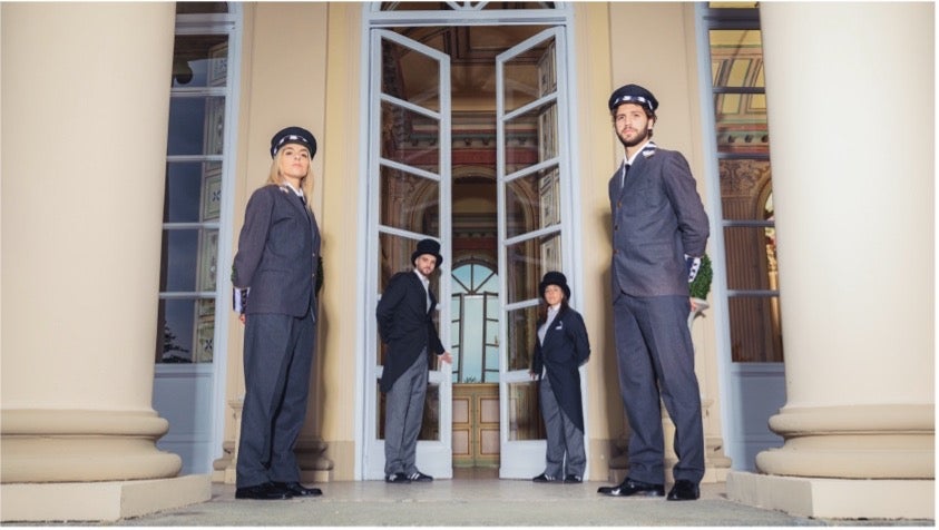 Image of people opening doors dressed up in uniform