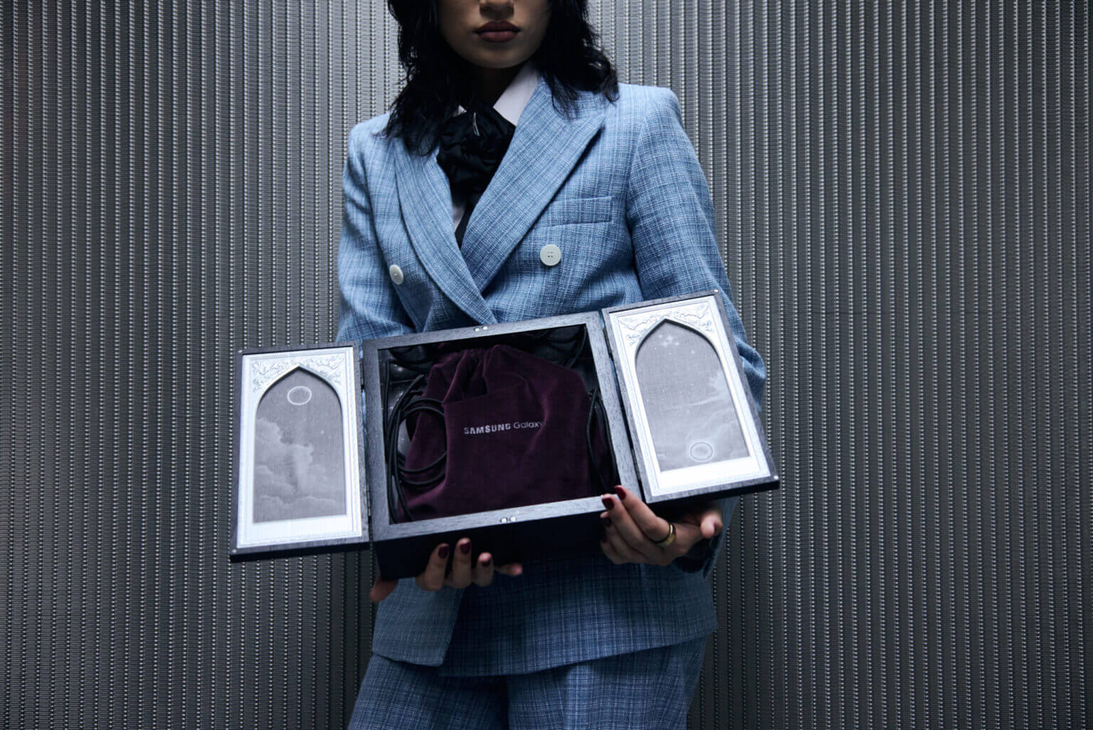 A woman holding a MSCHF box with the Galaxy Ring