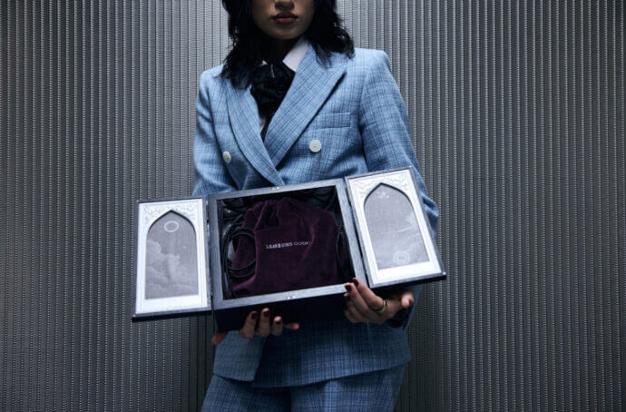 A woman holding a MSCHF box with the Galaxy Ring