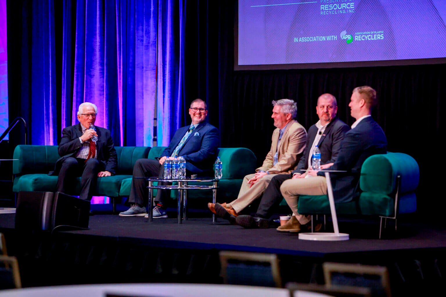 A panel of packaging experts converse on stage