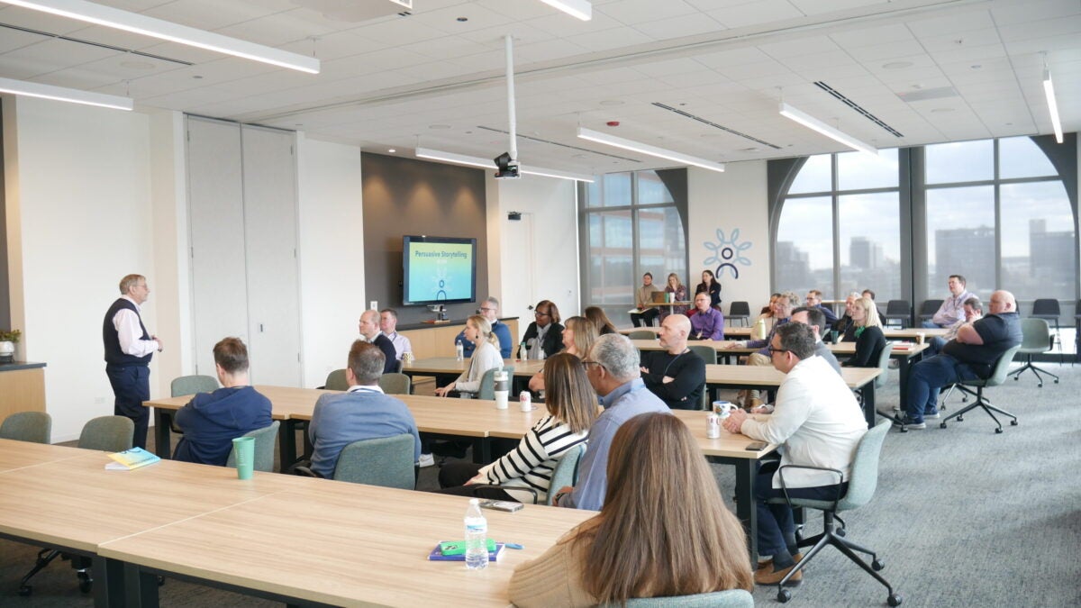 A group of people listening to Connections presentation