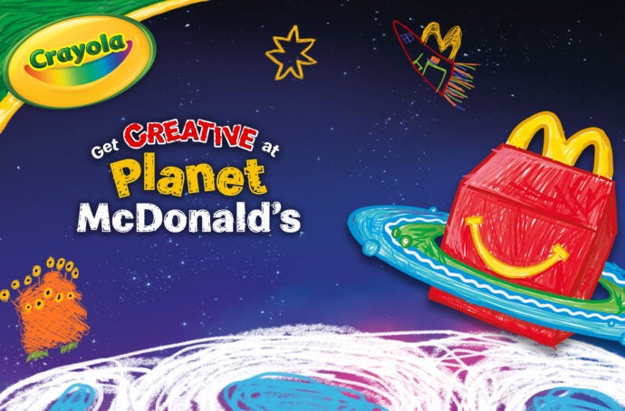 A McDonald's promotional poster with the text "Planet McDonald's" and a drawing of space with a Happy Meal box in the background