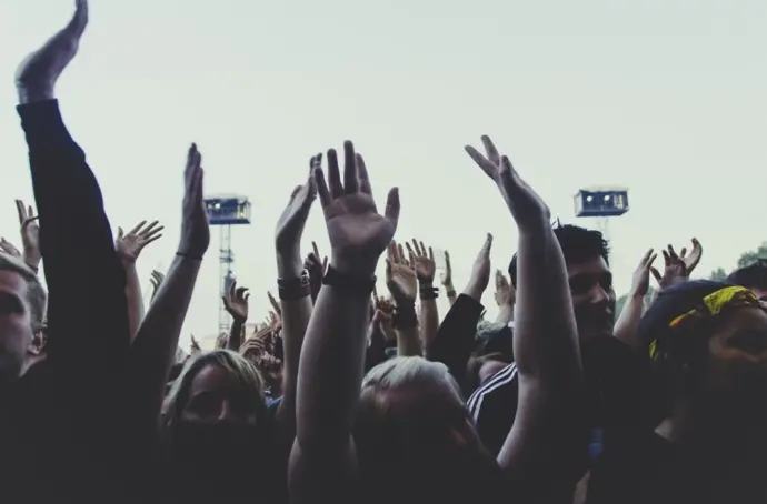 Young people with arms raised