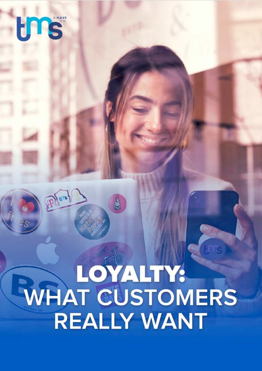 "Loyalty: what customers really want" white paper cover featuring a woman with a laptop looking at a phone
