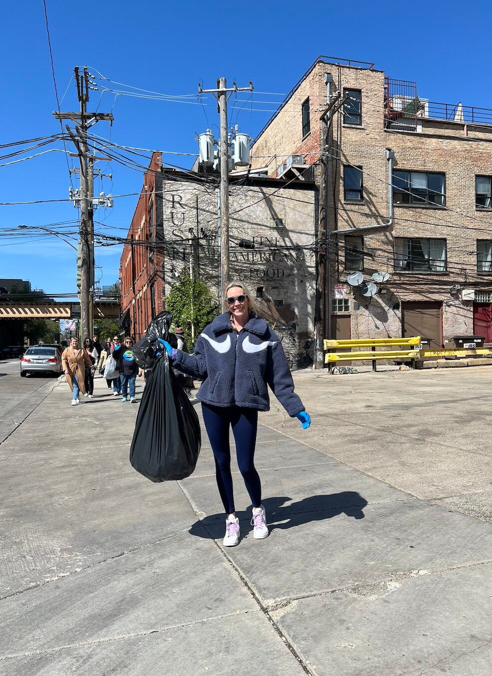 Woman with a trash bag outside