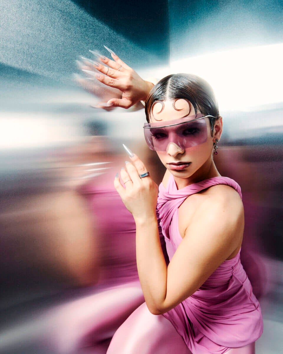 A woman in a pink dress with the Samsung Galaxy Ring