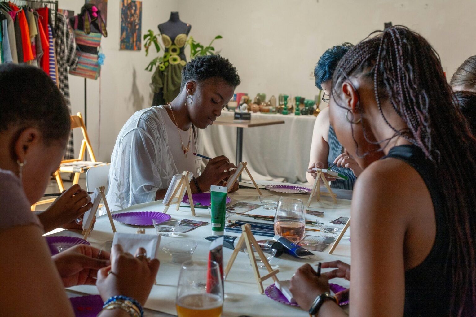 group of people sat in painting workshop