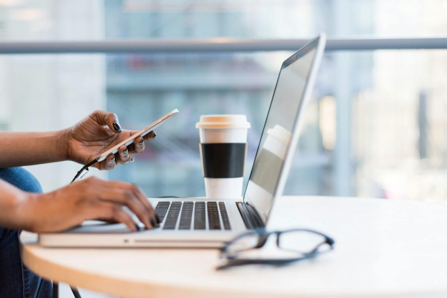 A woman typing on a computer