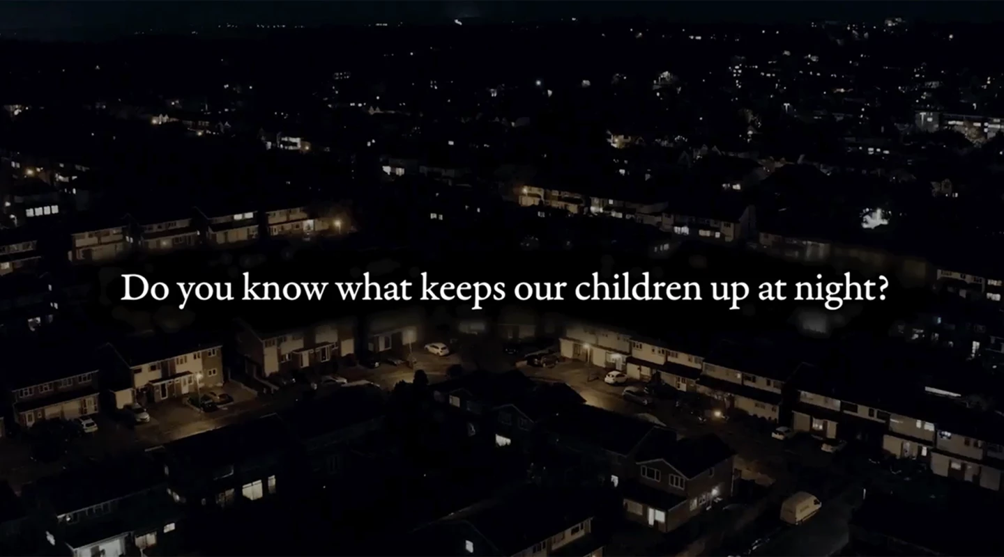 aerial view of suburban houses at night with text saying do you know what keeps our children up at night?
