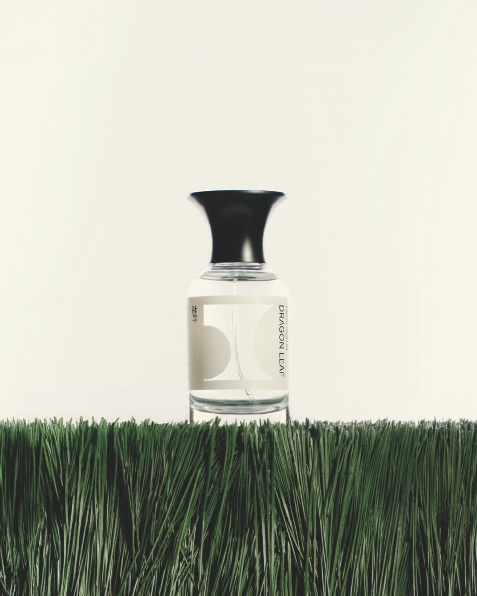 image of perfume bottle on grass