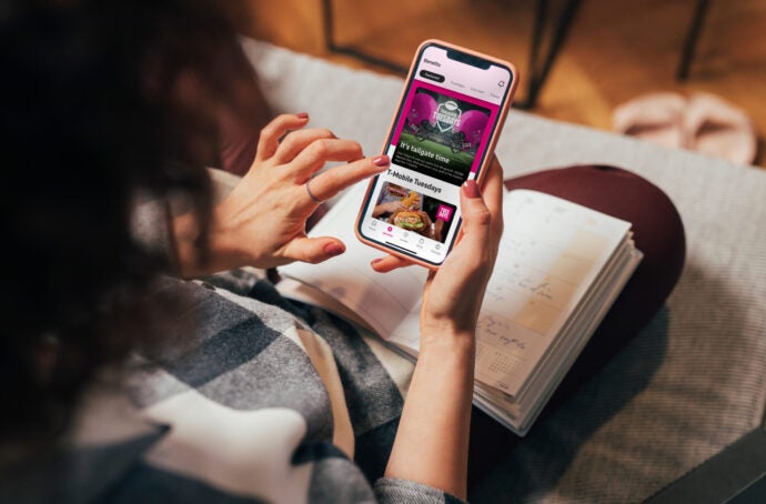 over the shoulder view of someone using the t-mobile app