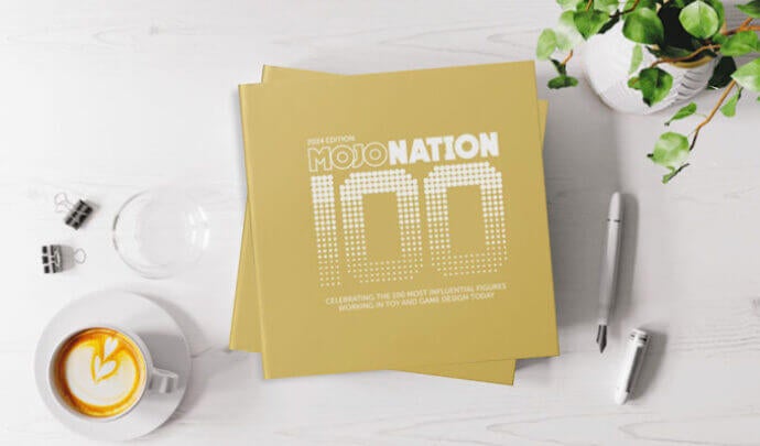 Image of a desk with gold cards stating "Mojo Nation 100"
