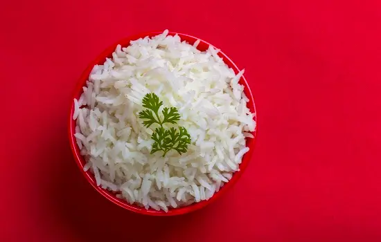Bowl of rice against red background