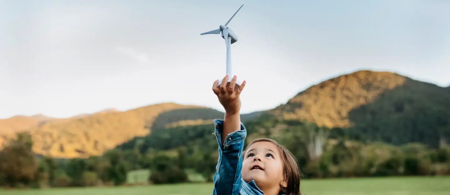 Child holding small wind turbine