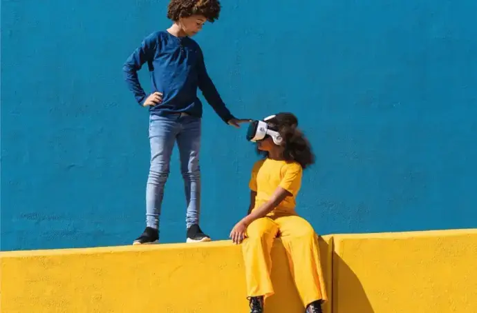 Two kids play with VR headset