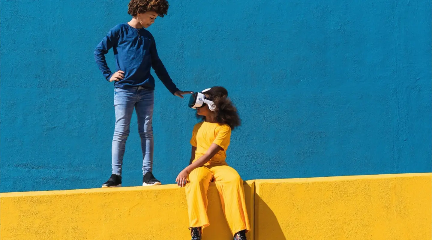 Two kids play with VR headset