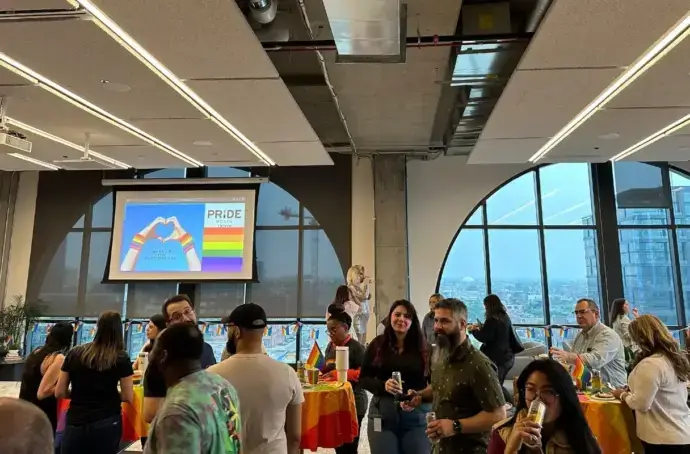 tms and HAVI employees conversing at the pride celebration