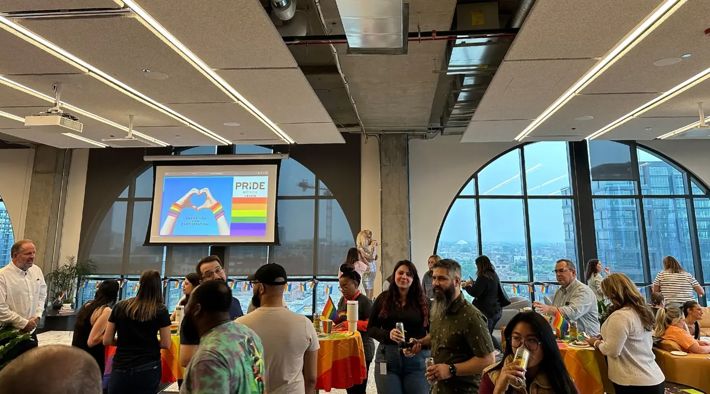 tms and HAVI employees conversing at the pride celebration